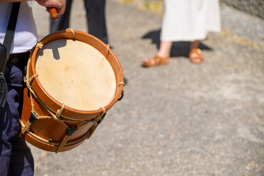 Musician with a traditional wooden drum at a festival The Concept of folk culture