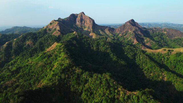 Slow pan view of the popular hiking spot in Batangas Philippines, Mt. Batulao features rolling green hills, natural trails, and breathtaking panoramic views of the tropical landscape.
