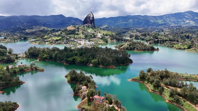 Drone panorama of El Pe&ntilde;ol Rock (La Piedra) overlooking Guatap&eacute;&rsquo;s turquoise lakes. Cinematic scenery of the lush green landscape and islands in the paradise-like setting of Antioquia, Colombia.
