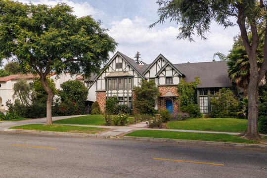 Modern suburban houses with cars in quiet residential street