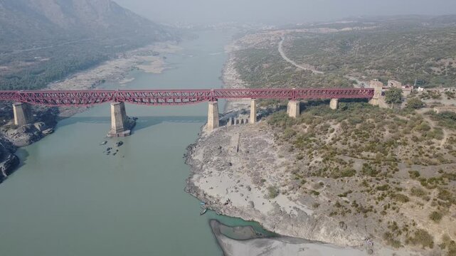 Drone footage of red attock bridge crossing indus river in pakistan valley