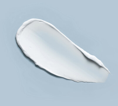 White cosmetic cream smear texture on blue