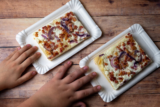 Children hands reaching for Hungarian langos flatbread