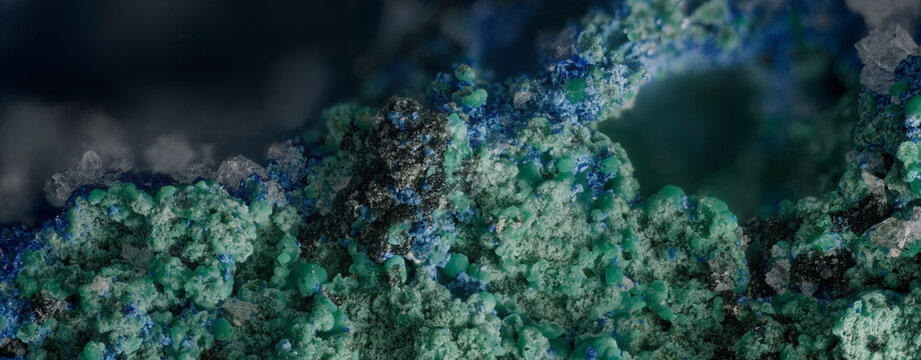 Microscopic panorama of Hemimorphite Azurite Malachite and Tenorite minerals from Altai mountains Russia at 5x magnification horizontal background for science and design