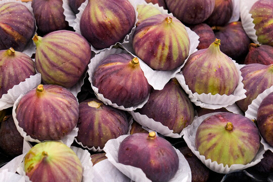 Purple figs in paper cups at market