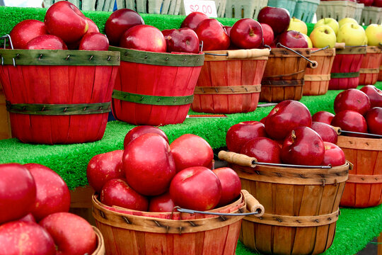 Red apples in wooden baskets at farmers market