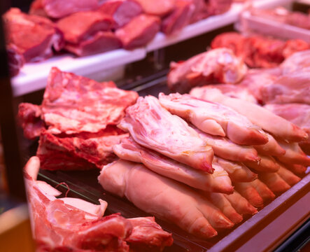 Raw pork legs on store counter