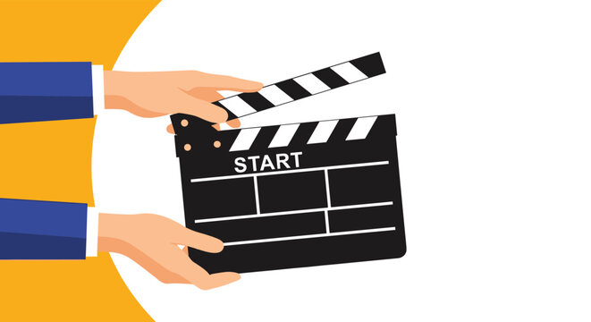 Two hands hold a professional black movie clapperboard with the word START written on it against a yellow circle.
