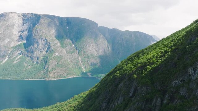 Aerial drone shot of the scenic fjord in Norway. Scandinavian nature. High mountains and deep fjords in the north. Concept of travel, vacation and arctic nature.

