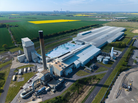 Aerial view of a large glass recycling and manufacturing facility with industrial processing plants and cooling fans in Goole, East Yorkshire, UK.