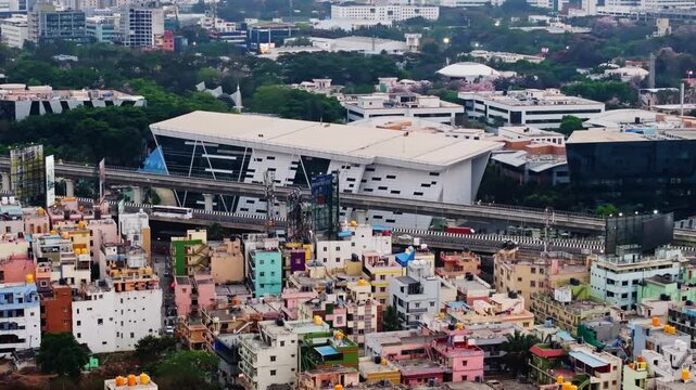 vehicles moving on express flyover with metro line, mobile signal tower, hoarding board and infosys building at electronic city, Bengaluru, karnataka, india. day time, stable shot, drone shot, 4k.