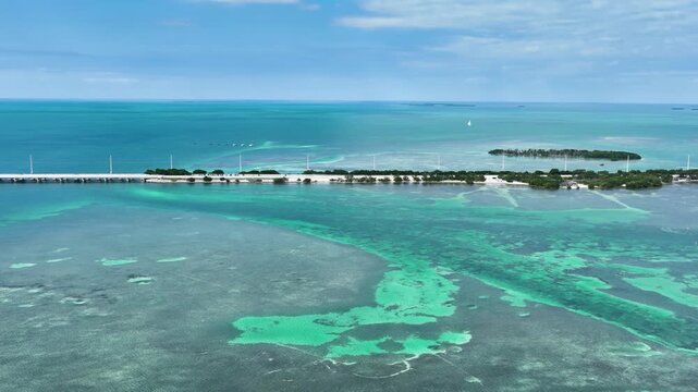 Cinematic aerial drone footage of the iconic Seven Mile Bridge and historic old bridge stretching across vibrant tropical waters.