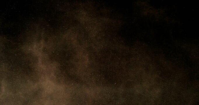 Super slow motion sandstorm and dust blizzard effect with airborne sand and fine particles, filmed at 500 fps on a high-speed camera. Isolated on black background, ideal as realistic VFX overlay.