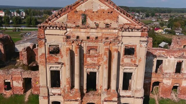 Ruined baroque facade with columns and pediment at Ruzhany Palace, Belarus &mdash; close up drone view