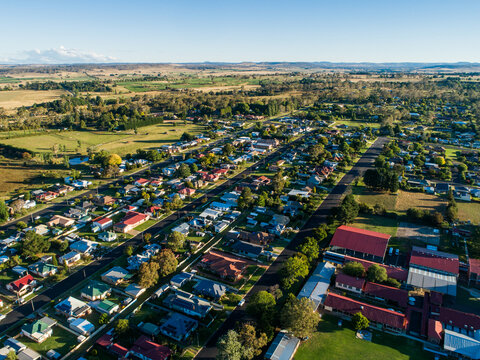 Neat town planning shown in aerial view over rural town in bright summer sunshine