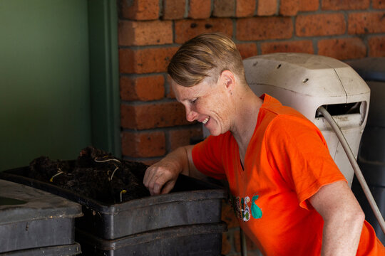 Australian woman in backyard beside worm farm
