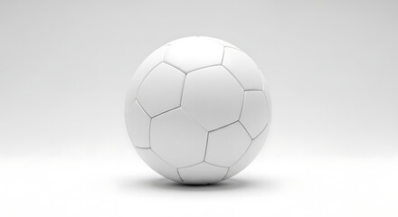 A soccer ball sits on a white surface with a subtle shadow underneath it