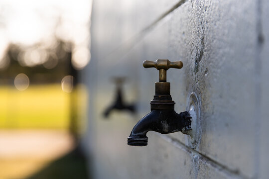 outdoor tap on the wall of a sports club