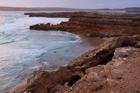 Pastel twilight colours over cliff tops along rugged eroded coastline
