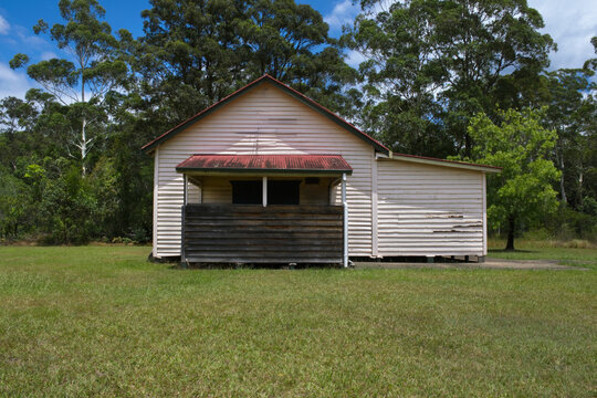 Small timber hall in countryside on a sunny day with gum trees