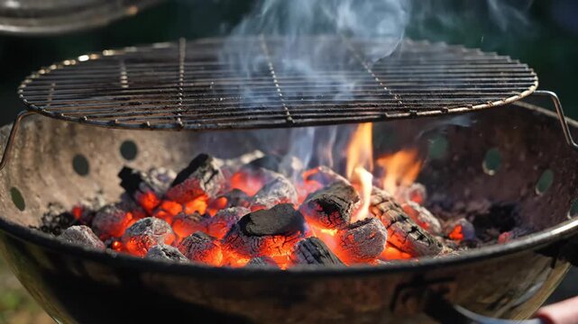 Glowing Red Hot Charcoal Briquettes Burning and Smoking in Round Barbecue Grill