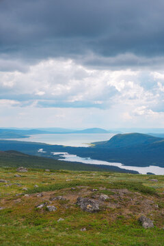 Panoramic view of Kungsleden hiking trail in Laponia World Heritage Site Sweden with vast arctic tundra landscape under summer sky