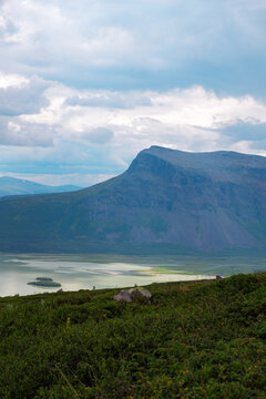 Aerial view of Rapa River delta and Skierfe mountain in Laponia Sweden with arctic glacial water and green wilderness landscape