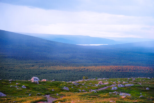 Majestic sunset over Kungsleden hiking trail in Laponia Sweden with golden light illuminating arctic tundra and mountain peaks