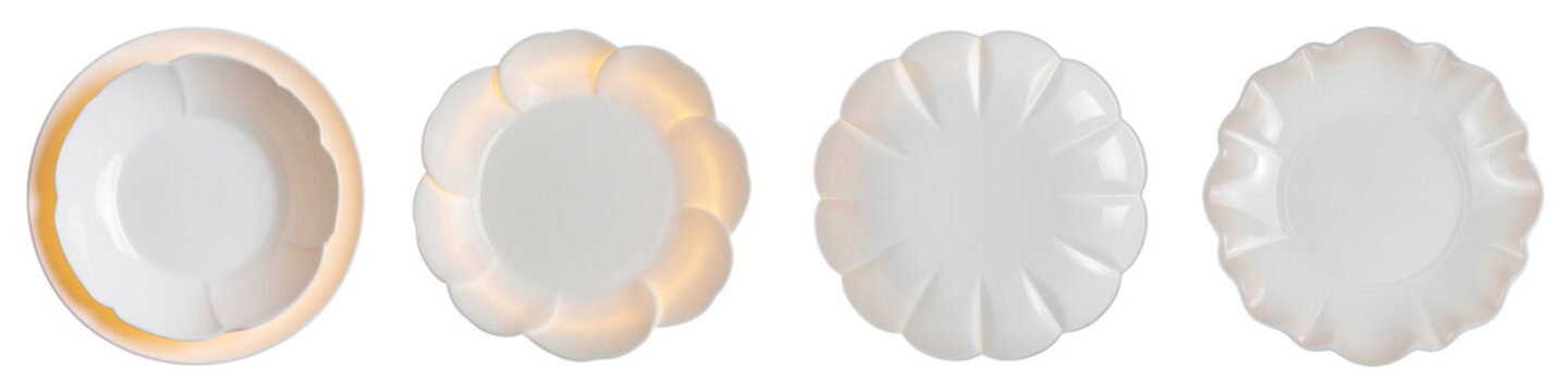 Four elegant white ceramic plates with decorative scalloped edges arranged in  row