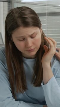 Vertical shot of young woman getting frustrated because of bad news received from anonymous IVF specialist at fertility consultation