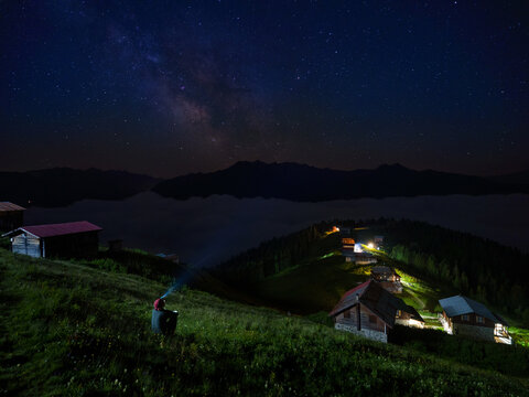 A man watching the Milky Way on the Pokut plateau. Black Sea highlands. Rize, T&uuml;rkiye. (Long exposure night shot, has grain)