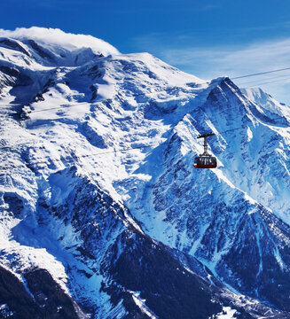 Red cable car traversing the slopes of Mont Blanc in the French Alps, France, Europe