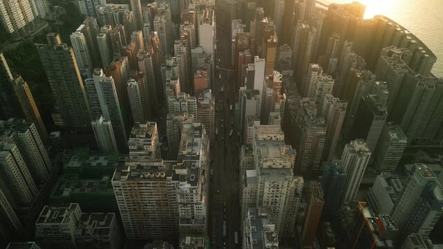Aerial drone view of Hong Kong skyline and harbor at sunset