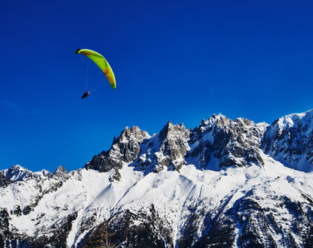 paraglider over a snowy mountainside in the French Alps, Chamonix, France, Europe