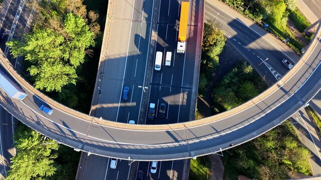 Aerial Drone Ascending Shot of Motorway Interchange Ramp Birmingham UK &mdash; Cars and Trucks on Curved Road