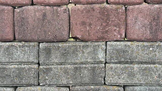 Paving stone samples top view close-up, textured cobble tiles arranged on display stand in hardware store, closeup top down framing