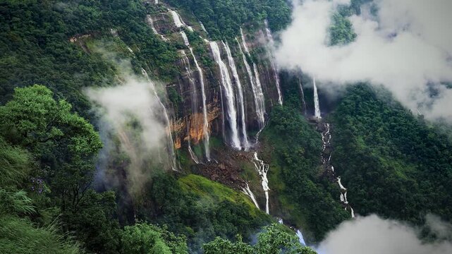 Panoramic View of Seven Sisters Waterfall in Meghalaya, Multiple Cascades Falling from Green Cliffs into Clouds, Scenic Monsoon Landscape of India