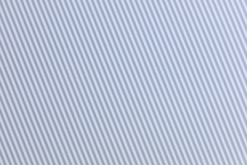 Strong lines texture background of diagonal stripes in grey and white that fills the entire surface area of the background © ir1ska
