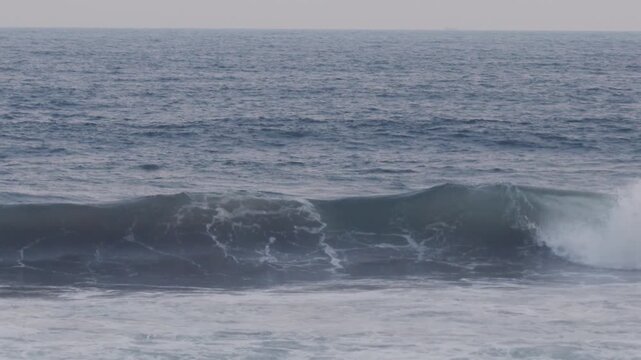 Ocean wave rolling and crashing in slow motion at the beach