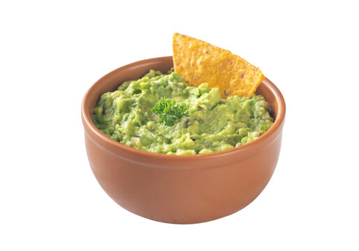 Fresh guacamole dip in terracotta bowl with tortilla chip, mexican food isolated on transparent background PNG