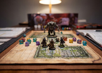 Fototapeta premium Tabletop fantasy game with miniatures dice and battle map