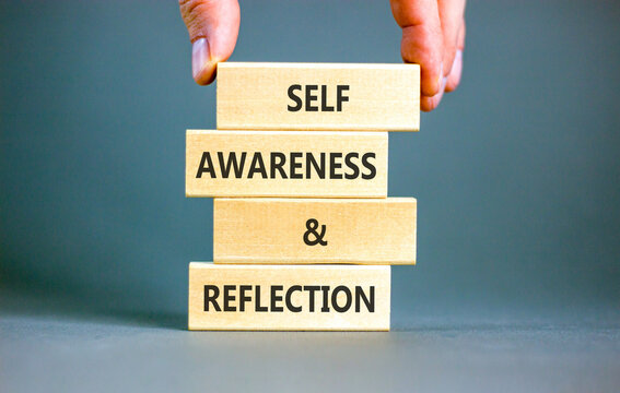 Self awareness and reflection symbol. Concept words Self awareness and reflection on beautiful wooden blocks. Beautiful grey background. Psychological self awareness reflection concept. Copy space.