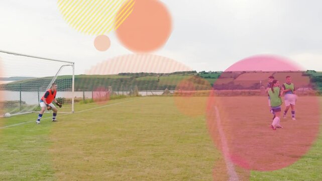 Keeper in orange bib picking ball, sending to restart soccer play, shapes overlaying players moving