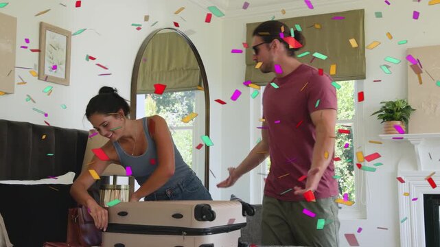 Couple sorting, zipping cream case on bed, woman packing bag, man lifting it, confetti marking trip