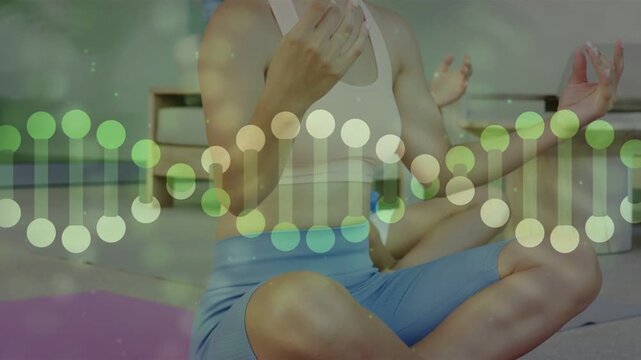 Woman forming meditative mudras on pink mat while helix dots fading up prompt shared yoga session