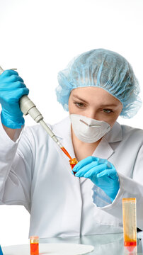 Young european female scientist pipetting orange reagent into microcentrifuge tube using micropipette