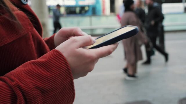 Businesswoman on the go using phone corresponds with clients, browses social media, runs a blog. High quality 4k footage