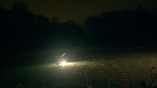 Ice rink skating practice session. Skater performing precise maneuvers on ice. Figure skater diligently refining sharp curves on icy surface under subdued illumination