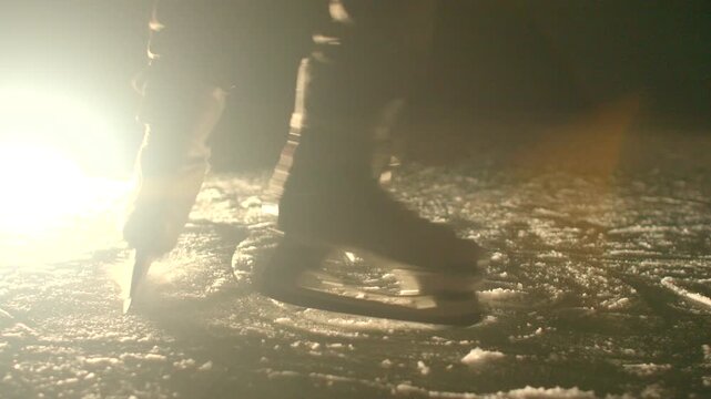 Detailed view of footwork and blade placement during skating session. Closeup shot capturing intricate foot and blade motion during skating exercises on icy terrain