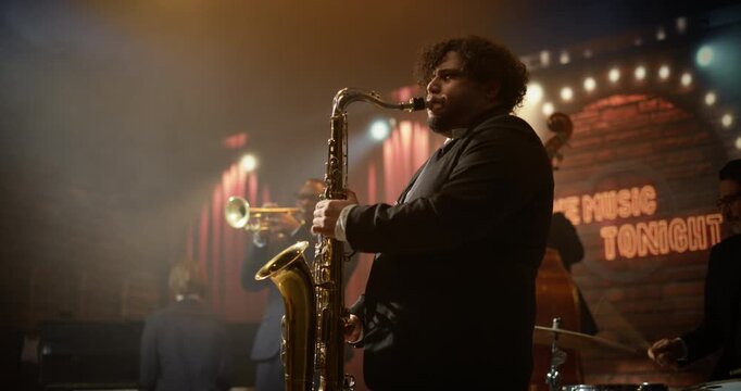 Male Saxophone Player Leads a Live Jazz Band on a Bar Stage, Playing a Soulful Concert Song as Trumpet, Piano, Bass, and Drums Drive the Music Event for the Audience.